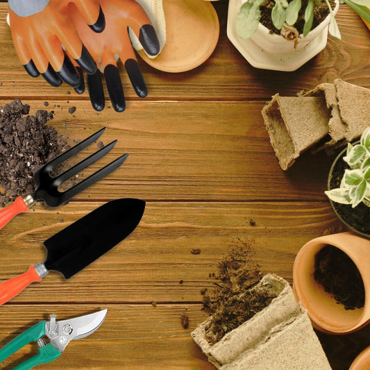 Gardening tools and materials on a wooden surface